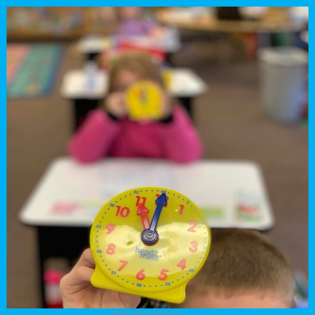 Students in a classroom telling time with an analog clock.